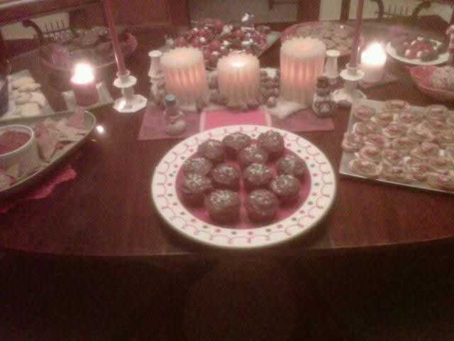 Elegant candlelit appetizer and dessert table at a catered event